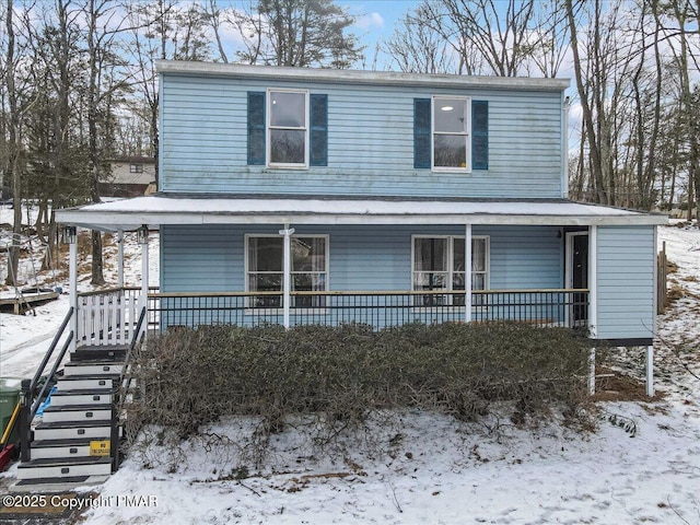 view of front of property with covered porch and stairs