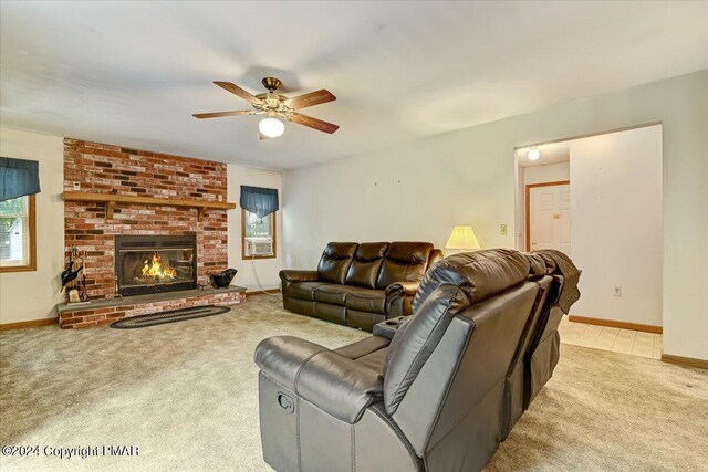 living area featuring a wealth of natural light, carpet, a fireplace, and baseboards