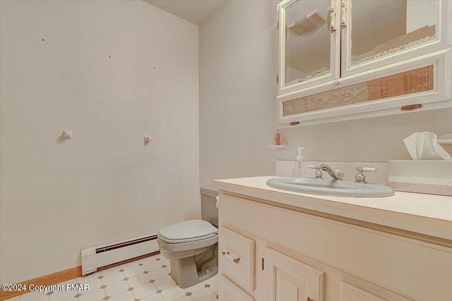 bathroom with a baseboard heating unit, vanity, toilet, and tile patterned floors