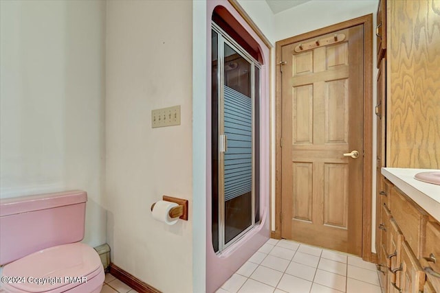 bathroom with vanity, toilet, and tile patterned floors