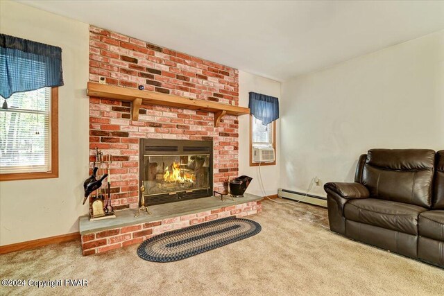 carpeted living area with baseboards, a brick fireplace, a baseboard radiator, and a healthy amount of sunlight