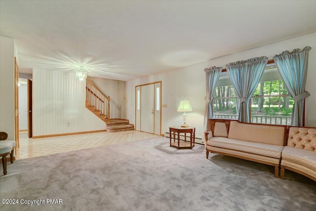 unfurnished room with carpet floors, a baseboard radiator, and stairs