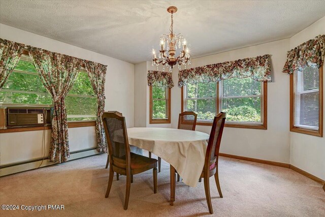 dining area featuring a notable chandelier, light colored carpet, baseboard heating, a textured ceiling, and baseboards