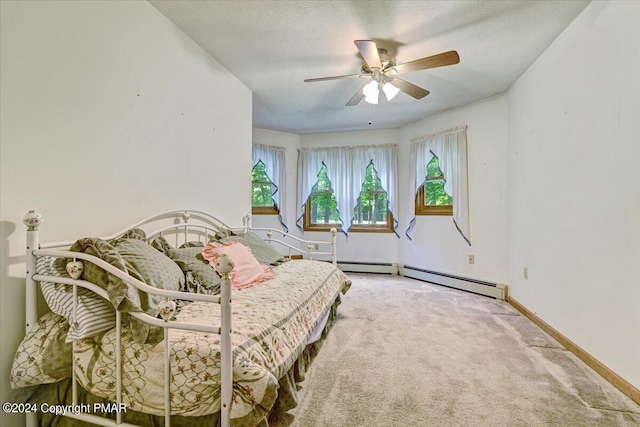 carpeted bedroom with a baseboard heating unit, ceiling fan, a textured ceiling, and baseboards