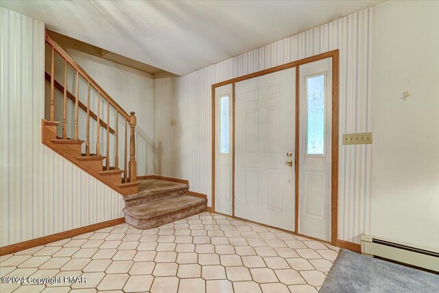 entrance foyer featuring stairs, a baseboard radiator, and wallpapered walls