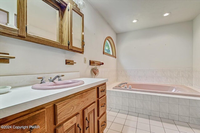 full bath featuring vanity, a bath, and tile patterned floors