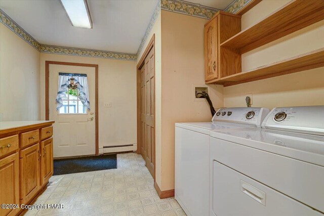 washroom with separate washer and dryer, baseboards, baseboard heating, cabinet space, and light floors