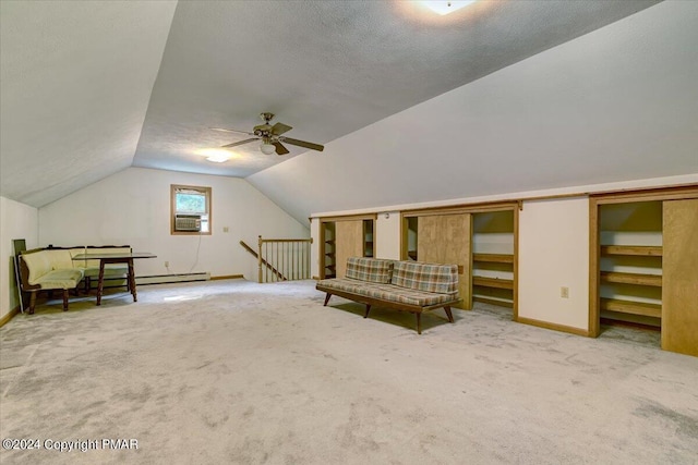 sitting room featuring carpet floors, lofted ceiling, a ceiling fan, a textured ceiling, and an upstairs landing