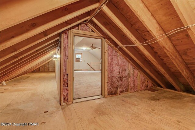 unfinished attic featuring an upstairs landing