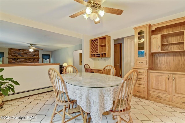 dining area featuring light floors, a baseboard radiator, and a ceiling fan