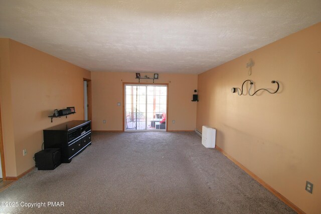 spare room featuring carpet floors and a textured ceiling