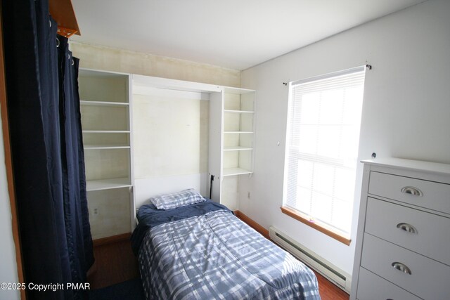 bedroom featuring a baseboard radiator and dark wood-type flooring