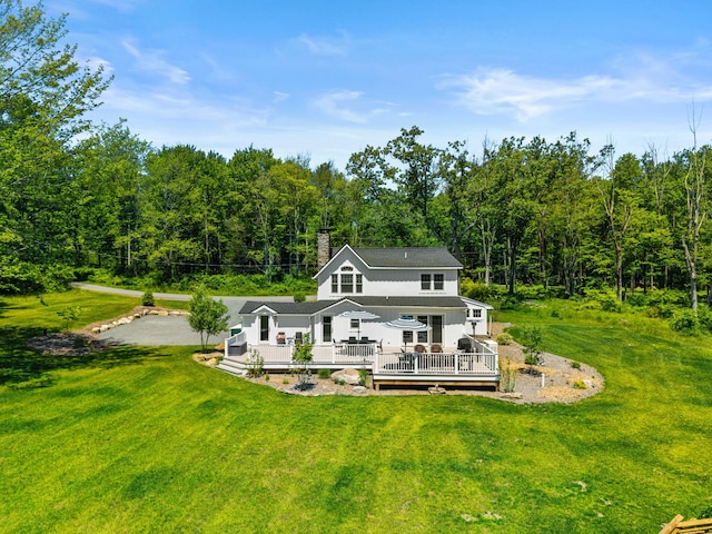 5126 Beattys Cir, Buck Hill Falls, PA 18323 - rear view of property featuring a wooden deck, a view of trees, a yard, and a chimney