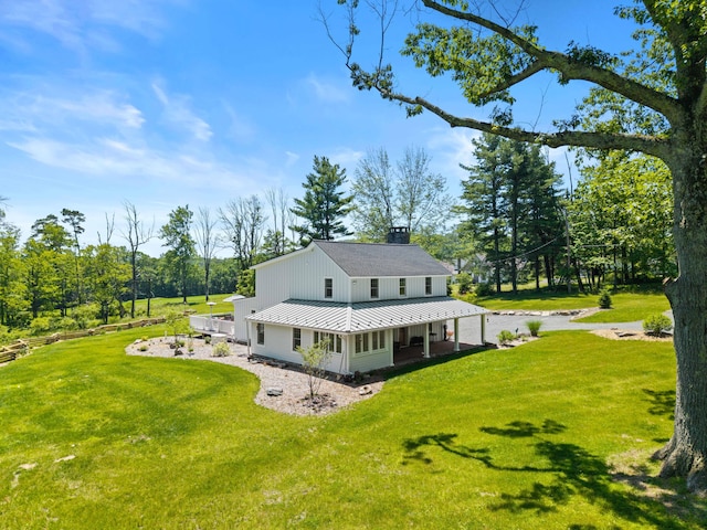 5126 Beattys Cir, Buck Hill Falls, PA 18323 - back of property featuring a porch, a yard, a chimney, and a metal roof