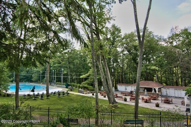 5126 Beattys Cir, Buck Hill Falls, PA 18323 - view of community with an outdoor structure, a patio, and a swimming pool