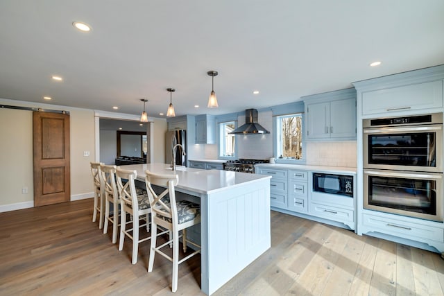 5126 Beattys Cir, Buck Hill Falls, PA 18323 - kitchen with stainless steel double oven, wall chimney range hood, black microwave, light countertops, and recessed lighting