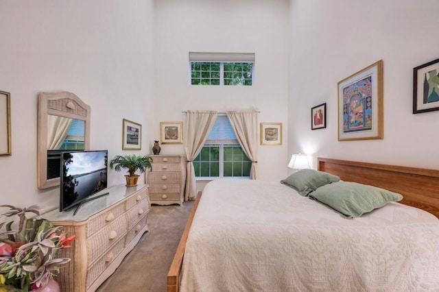 1218 Clymer Ln, Pocono Pines, PA 18350 - carpeted bedroom featuring a towering ceiling and multiple windows