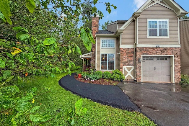 1218 Clymer Ln, Pocono Pines, PA 18350 - view of home's exterior with asphalt driveway, stone siding, a chimney, and a garage