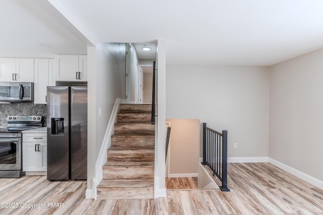 stairs featuring wood-type flooring