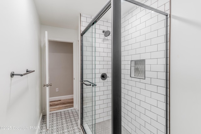 bathroom featuring tile patterned floors and tiled shower