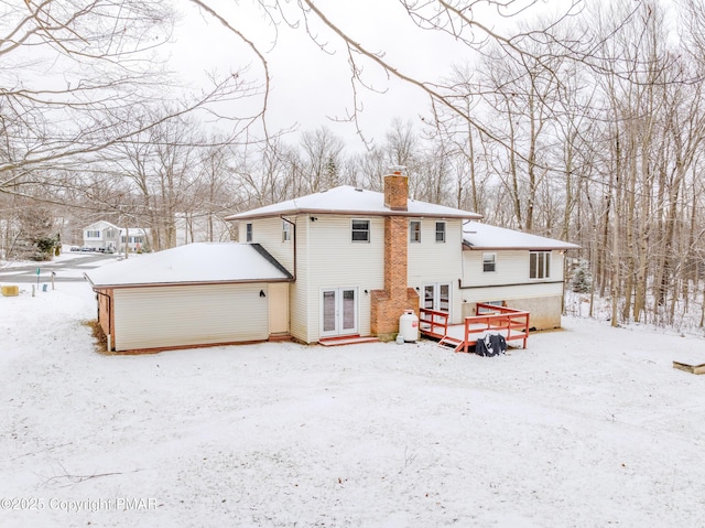 3011 Minqua Cir, Tobyhanna, PA 18466 - snow covered house with a chimney, french doors, and a garage