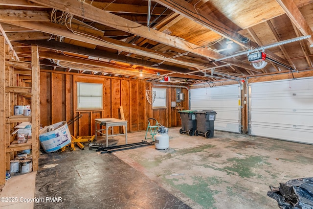 garage with electric panel and a garage door opener