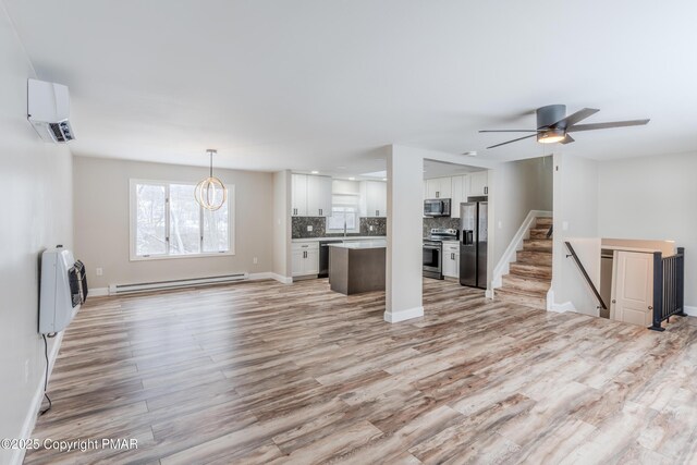 3011 Minqua Cir, Tobyhanna, PA 18466 - unfurnished living room with a baseboard heating unit, a wall mounted air conditioner, light wood-style flooring, heating unit, and baseboards