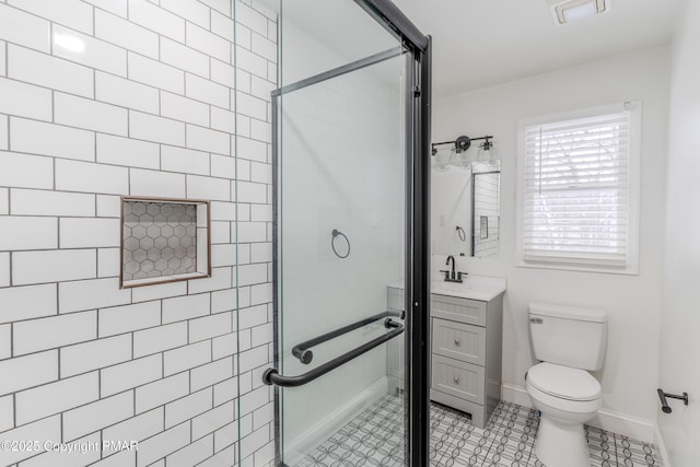 bathroom featuring toilet, walk in shower, tile patterned floors, and vanity