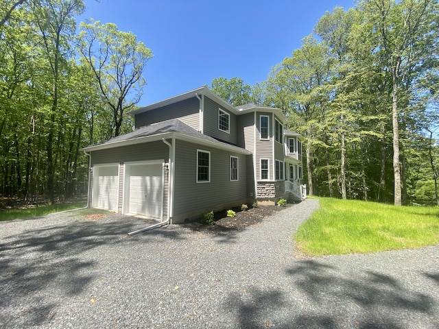 130 Sugar Hill Rd, Saylorsburg, PA 18353 - view of home's exterior featuring an attached garage and gravel driveway