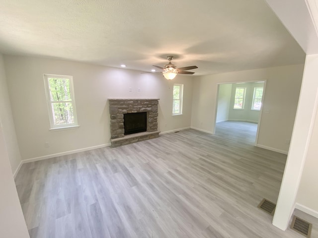 130 Sugar Hill Rd, Saylorsburg, PA 18353 - unfurnished living room with ceiling fan, a stone fireplace, baseboards, and recessed lighting