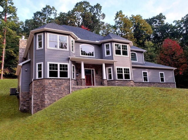 130 Sugar Hill Rd, Saylorsburg, PA 18353 - view of front facade with stone siding, a front yard, cooling unit, and a chimney