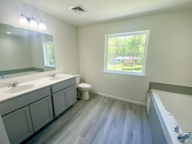 130 Sugar Hill Rd, Saylorsburg, PA 18353 - bathroom with a garden tub, wood finished floors, toilet, and double vanity
