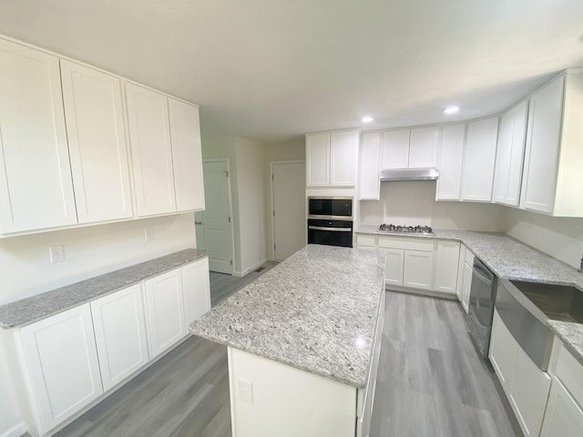 130 Sugar Hill Rd, Saylorsburg, PA 18353 - kitchen with stainless steel appliances, light wood-type flooring, a kitchen island, under cabinet range hood, and white cabinetry