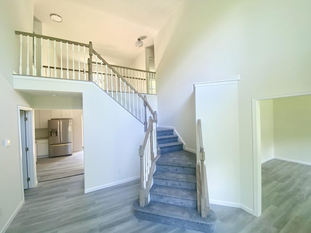 130 Sugar Hill Rd, Saylorsburg, PA 18353 - stairs with a towering ceiling, wood finished floors, and baseboards