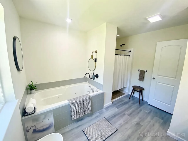 130 Sugar Hill Rd, Saylorsburg, PA 18353 - bathroom featuring a tub with jets, wood finished floors, and curtained shower