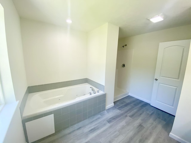 130 Sugar Hill Rd, Saylorsburg, PA 18353 - bathroom featuring a jetted tub, wood finished floors, a shower, and baseboards