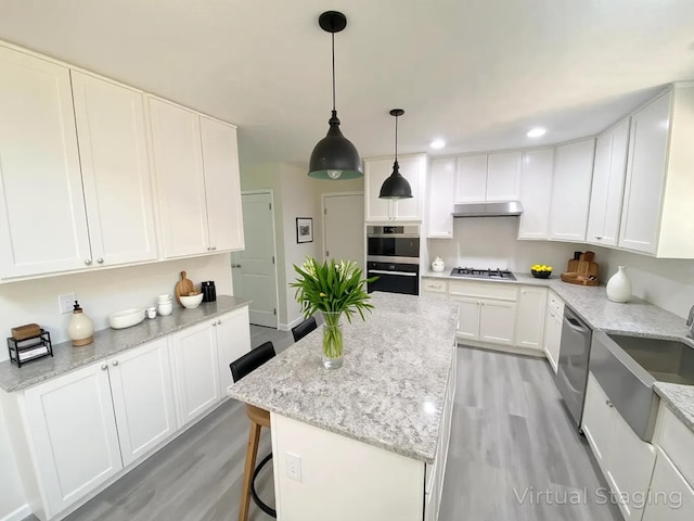 130 Sugar Hill Rd, Saylorsburg, PA 18353 - kitchen featuring appliances with stainless steel finishes, a sink, under cabinet range hood, light wood-style flooring, and white cabinets