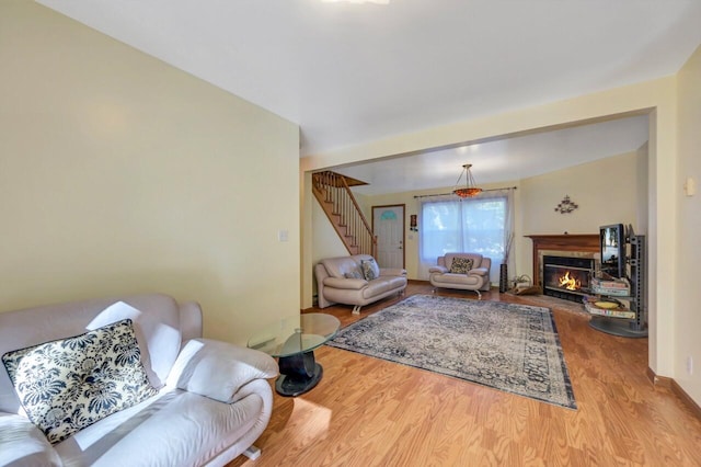295 Wyomissing Dr, Pocono Lake, PA 18347 - living area with wood finished floors, stairs, and a glass covered fireplace
