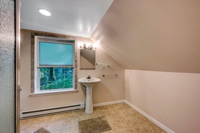 295 Wyomissing Dr, Pocono Lake, PA 18347 - bathroom with a baseboard heating unit, vaulted ceiling, and tile patterned flooring