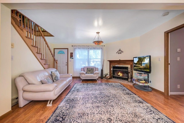 295 Wyomissing Dr, Pocono Lake, PA 18347 - living room featuring wood finished floors, a premium fireplace, stairs, and a baseboard radiator