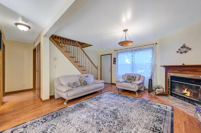 295 Wyomissing Dr, Pocono Lake, PA 18347 - living area with stairway, a high end fireplace, and wood finished floors