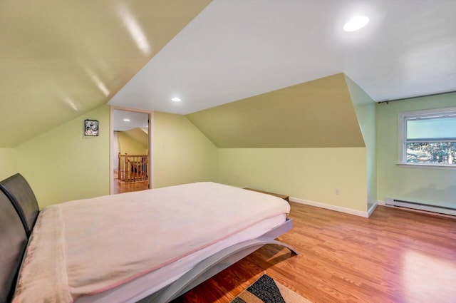 295 Wyomissing Dr, Pocono Lake, PA 18347 - bedroom with baseboard heating, wood finished floors, vaulted ceiling, and recessed lighting