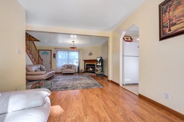 295 Wyomissing Dr, Pocono Lake, PA 18347 - living room with light wood finished floors, stairs, and a glass covered fireplace
