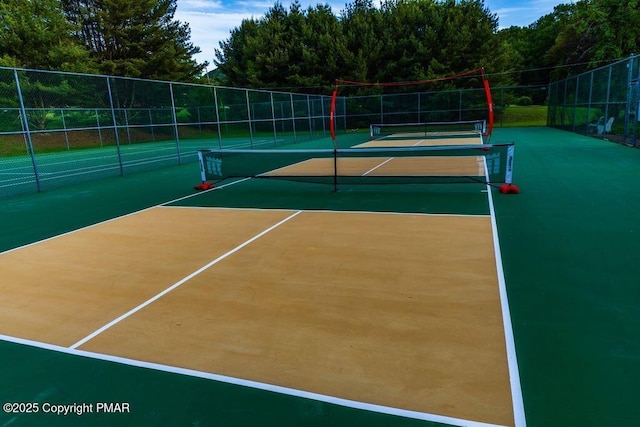 view of tennis court featuring basketball hoop