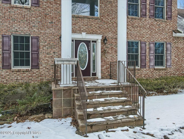 view of snow covered property entrance