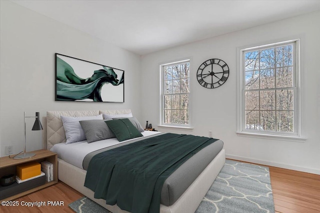 bedroom with hardwood / wood-style flooring