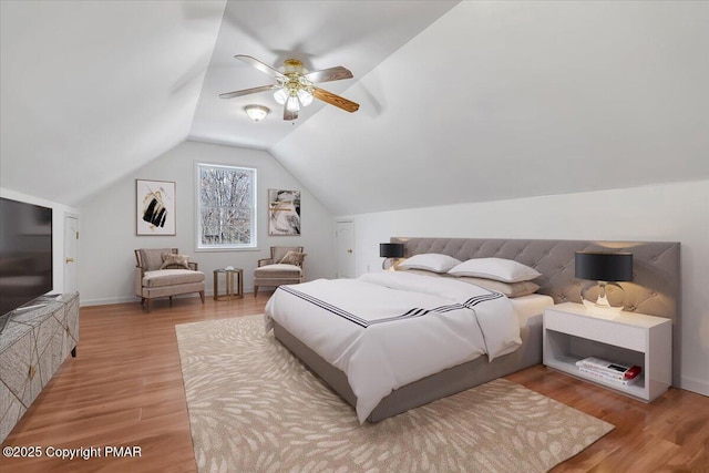 bedroom featuring lofted ceiling, ceiling fan, and light wood-type flooring