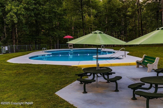 view of pool featuring a yard and a patio area