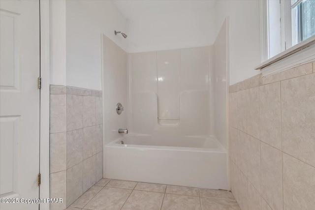 bathroom featuring tile walls, tile patterned flooring, and shower / tub combination