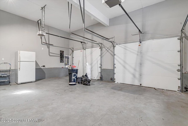 garage featuring a garage door opener, electric panel, and white fridge